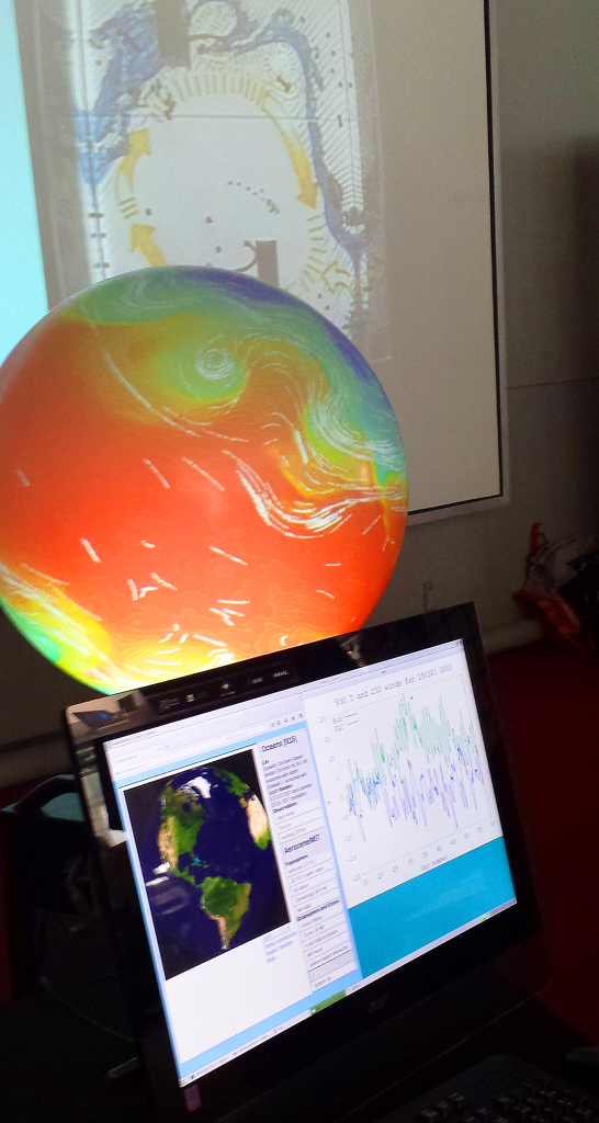 The iGlobe with a projection of the Pacific Garbage Patch in the background. (Credit: Lauren Hinkel)